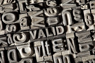 Old lead letters forming the word VALID