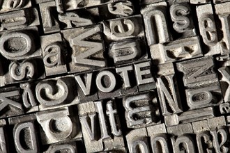 Old lead letters forming the word VOTE