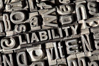 Old lead letters forming the word LIABILITY