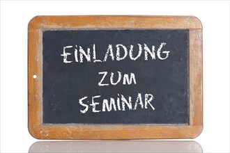 Old school blackboard with the words EINLADUNG ZUM SEMINAR