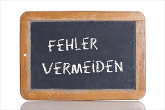 Old school blackboard with the words FEHLER VERMEIDEN