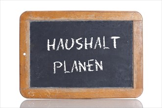 Old school blackboard with the words HAUSHALT PLANEN