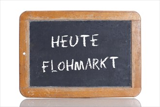 Old school blackboard with the words HEUTE FLOHMARKT