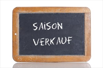 Old school blackboard with the words SAISON VERKAUF