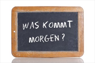 Old school blackboard with the words WAS KOMMT MORGEN?
