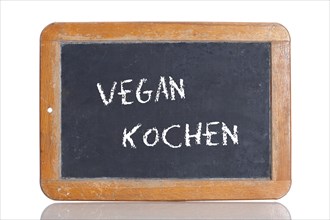 Old school blackboard with the term VEGAN KOCHEN