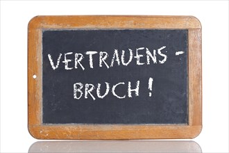 Old school blackboard with the term VERTRAUENSBRUCH
