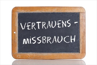 Old school blackboard with the term VERTRAUENSMISSBRAUCH