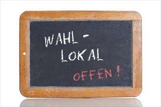 Old school blackboard with the term WAHLLOKAL OFFEN