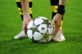 BVB player taking the Champions League ball into his hands