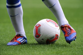 Players legs wearing adidas football boots and the adidas Torfabrik anniversary ball for the 50th Bundesliga season