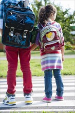 Children carrying school bags on the way to school