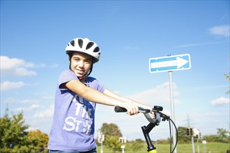 Girl wearing a bike helmet at a traffic awareness course