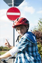Boy wearing a bike helmet at a traffic awareness course