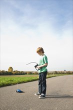 Boy playing with his radio-controlled model car