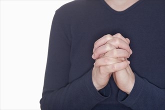 Woman praying with her hands clasped