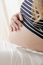 Pregnant woman holding a hand on her belly