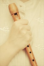 Hand holding a flute