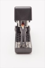 Figurine of businessman trapped by a stapler