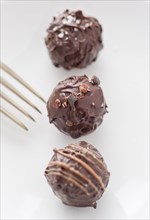 Three chocolate truffles and a fork