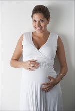 Pregnant woman holding hands on her stomach