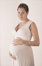 Pregnant woman holding hands on her stomach