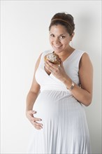 Pregnant woman eating a cinnamon roll