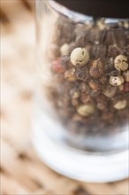 Closeup of mill with peppercorns
