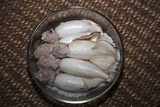 Cooked squid tubes filled with minced pork on rice