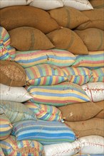 Plump bags of rice stacked in a rice warehouse