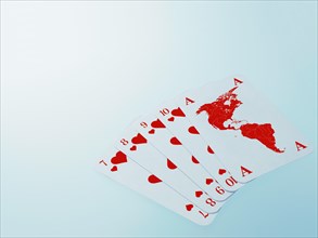 Playing cards with a map of North America and South America