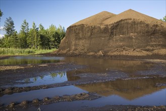 Mound of topsoil in a commercial sandpit after a heavy rainfall