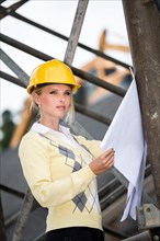 Young female architect with hard hat at a construction site