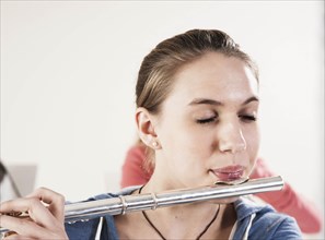 Teenage girl playing the flute