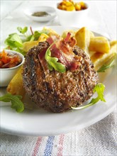 Char-grilled beef burger with chunky chips and salad