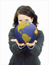 Young businesswoman holding a globe