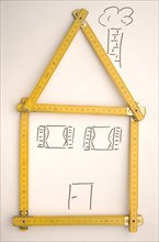 Folding rule in the shape of a house
