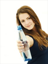 Young woman holding a water bottle to the front