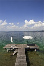 Lake Starnberg with bathing jetty and parasol