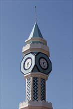 Tower with clock and blue ceramic tiles
