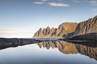 Mountain peaks at Tungeneset reflected in small natural basin
