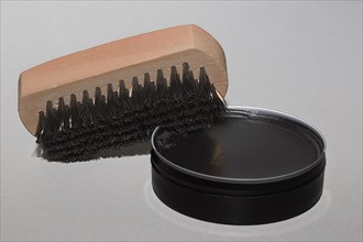 Shoe brush with black shoe polish