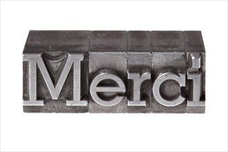 Old lead letters forming the word 'Merci'