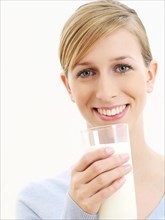 Young woman holding a glass of milk