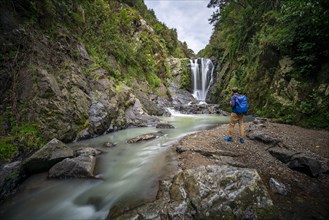 Hiker in front of Piroa Waterfall