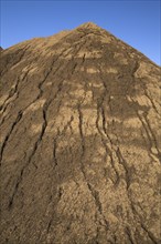 Mound of sand in a commercial sandpit after a heavy rainfall