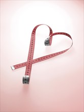 Pink tape measure shaped as a heart