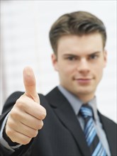 Businessman making a thumbs up gesture