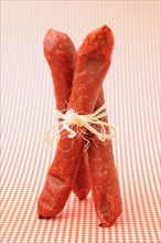 Three salami tied together