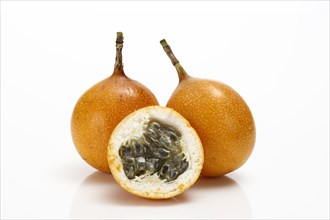 Two whole and one half of a Granadilla or Passion Fruit (Passiflora caerulea)